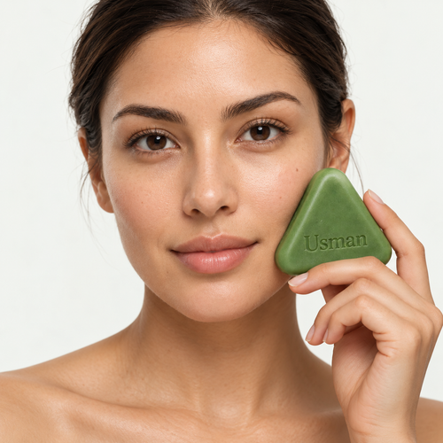 Usman shampoo bar held beside a model’s face